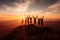 Silhouette of friends cheering on top of mountain