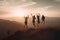 Silhouette of friends cheering on top of mountain