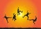 Silhouette of friends jumping over meadow on golden sunrise background, happy life, winning and achievement concept