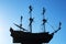 Silhouette of a frigate on a blue clear sky. Three-masted sailing ship soaring in the air