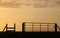 Silhouette gate and stile at sunset