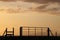 Silhouette gate and stile at sunset