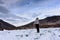 Silhouette of girl back view looking up at the sky on a flying paraglider stays on a pile of beautiful ice hummocks near