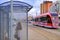 Silhouette of a girl at the bus stop. City view. City tram. Tram on light rail transport in St. Petersburg.