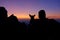 SILHOUETTE: Girl and her dog watch the sunset after a hiking trip in Julian Alps