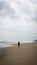 Silhouette of an girl with hijab walking alone at the Batu Burok Beach