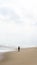 Silhouette of an girl with hijab walking alone at the Batu Burok Beach