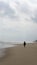 Silhouette of an girl with hijab walking alone at the Batu Burok Beach