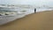 Silhouette of an girl with hijab walking alone at the Batu Burok Beach