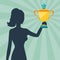 Silhouette of girl holding prize cup