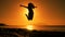 Silhouette of girl jumping at sunrise