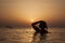 Silhouette of a girl in ocean on sunset,ocean woman in sunrise l