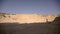 Silhouette of a girl and a pianist against a background of yellow mountains and stones. Aerial view.