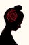 A silhouette of a girl`s head, with a red rope with knots on it as a keepsake