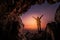 Silhouette of a girl standing in front of the entrance to the cave. Freedom concept. Woman Christians raising their hands in