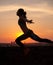 Silhouette of Girl streching at Sunrise or Sunset