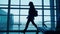 Silhouette of girl walking on airport terminal