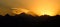 SILHOUETTE: Golden morning sun gently illuminates the mountain range in Himalaya