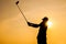 Silhouette of Golfer Drive Golf with Orange Background