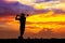 Silhouette golfer hit sweeping on sunset background. Golfer young man playing golf during beautiful sunrise sky with city