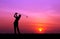 Silhouette golfer playing golf at beautiful sunset