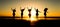 Silhouette of group of friends are having fun, having fun on the beach in the evening sunset