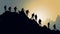 Silhouette of group of hikers on mountain at night