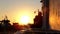 Silhouette of group of unrecognizable senior people talking and relaxing on a bench by the port ovelooking the fishing