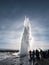 Silhouette, groups of tourist watching natural hot spring geyser erupting in Strokkur, Iceland