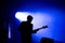 Silhouette of a guitar player on the stage
