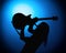 Silhouette guitarists of a rock band with guitar on blue background