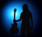 Silhouette guitarists of a rock band with guitar on blue background