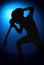 Silhouette guitarists of a rock band with guitar on blue background