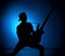 Silhouette guitarists of a rock band with guitar on blue background