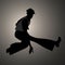 Silhouette of guy wearing wide trousers, dancing Northern Soul