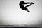 Silhouette of gymnast on trampoline