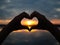 Silhouette hands to be heart shape on sunset background. Happy, Love, Valentine`s day idea, sign, symbol, concept