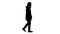 Silhouette Handsome fashionable man in a winter stylish coat walking.