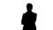 Silhouette Handsome young businessman standing arms crossed, smiling confidently.