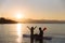 Silhouette of happiness boy and girl sitting on sup surf at the ocean. Concept lifestyle, sport, love