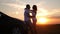 Silhouette of happiness couple stay near the new car under sky. Beautiful young couple standing near car at sunset.