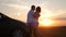 Silhouette of happiness couple stay near the new car under sky. Beautiful young couple standing near car at sunset.