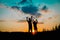 Silhouette of happy boy and girl enjoy sunset nature
