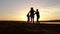 Silhouette, happy child with mother and father, family at sunset, summertime. Run, raising baby up in the air, hugs, love, playing