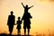 Silhouette, happy children with mother and father