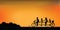 Silhouette of happy family cycling tandem bicycle with beautiful sky at sunset