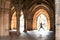 Silhouette of happy girl jumping high up in cloisters of Glasgow