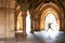 Silhouette of happy girl jumping high up in cloisters of Glasgow University