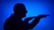 Silhouette of happy senior man dancing silly on blue background. Male`s face in profile having fun