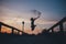 Silhouette of a happy woman jumping in sand at sunset